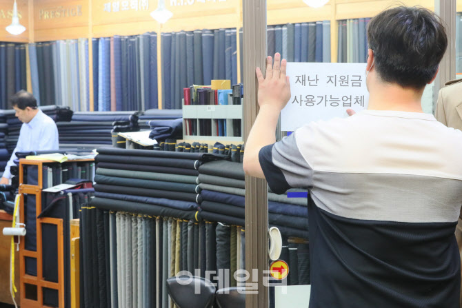 [포토]'재난지원금 사용가능업체' 붙이는 한 직원