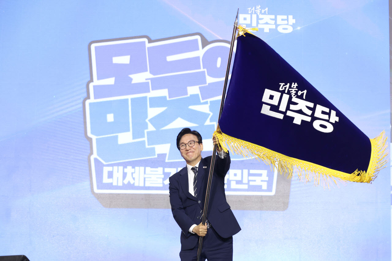 [포토]당기 흔드는 김민석 더불어민주당 신임 대표