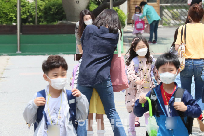첫 등교를 마친 학생, 어머니와 포옹                                                                                                                                                                