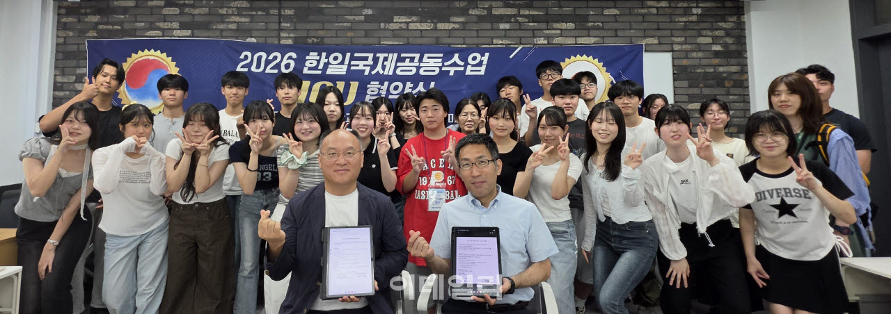 최명호 수도전기공고 교장(왼쪽)과, 호소다 마사토시 나가사키현립고등학교 교감이 MOU 체결후 양교 학생들과 함께 기념 촬영을 하고 있다(사진=수도전기공고)