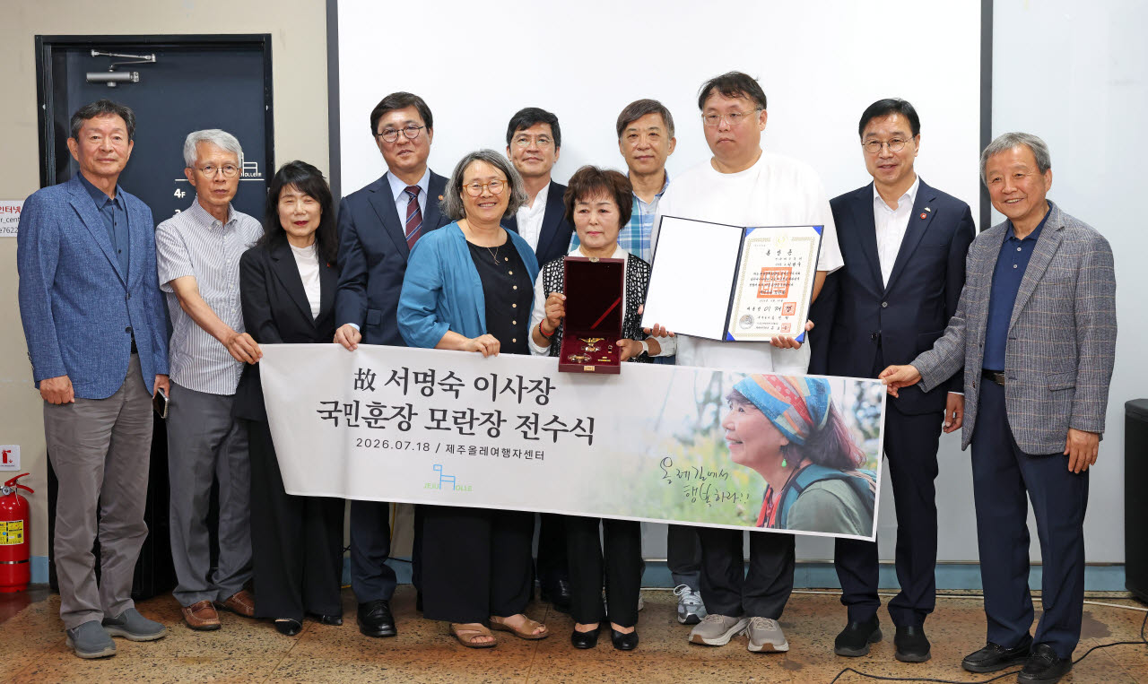 최휘영(왼쪽에서 네 번째) 문화체육관광부 장관이 18일 제주 서귀포시 제주올레 여행자센터에서 열린 고(故) 서명숙 제주올레 이사장 국민훈장 모란장 추서식에서 유족에게 훈장을 전수한 뒤 기념촬영을 하고 있다. (사진=문체부)