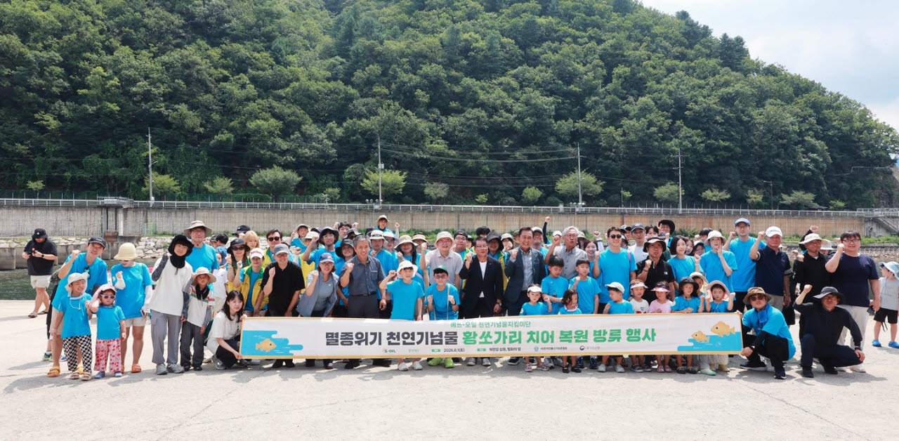 지난 1일 강원도 화천군 화천읍에서 열린 황쏘가리 치어 방류 봉사활동에 참가한 에쓰오일 임직원과 가족들이 기념촬영을 하고 있다.(사진=에쓰오일 제공)