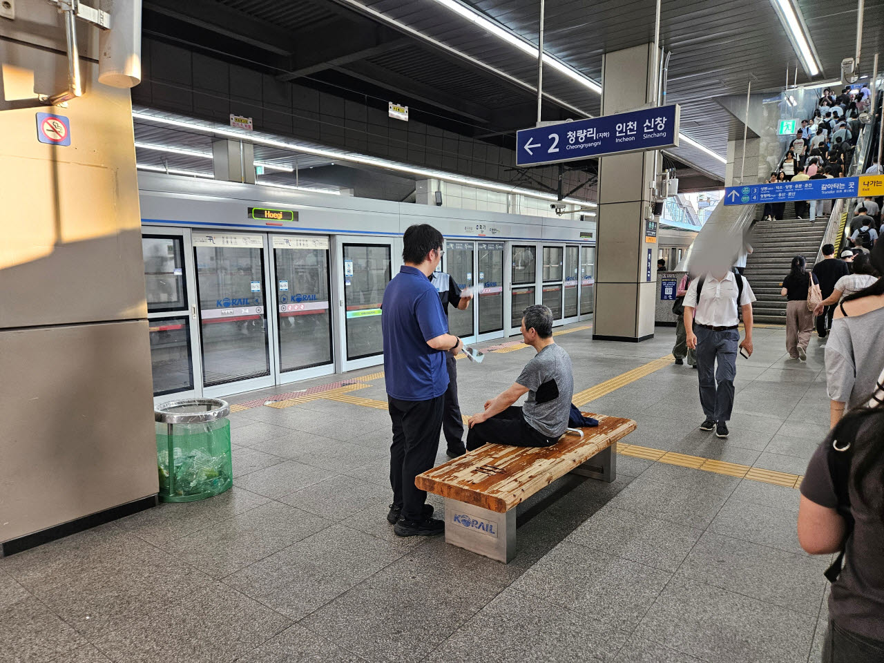 4일 서울 동대문구 회기역에서 역무원들이 의사소통이 어려운 노인에게 부채질을 하며 열을 식혀주고 있다. 노인은 체온이 38도를 넘어 온열질환이 의심됐으며, 이후 보호자 확인 등을 거쳐 병원으로 이송됐다. (사진=안치영 기자)