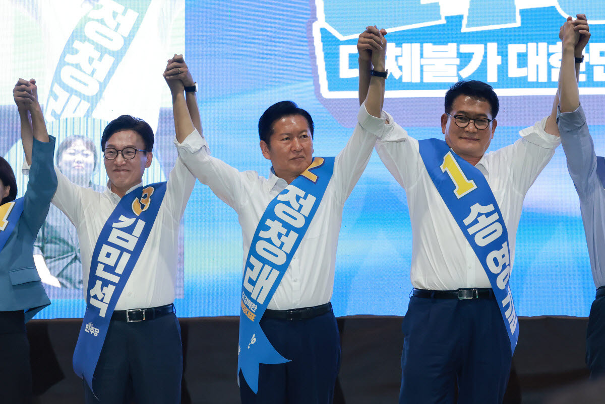 더불어민주당 김민석· 정청래·송영길 당 대표 후보가 9일 강원도 횡성국민체육센터에서 열린 민주당 대표·최고위원 후보자 강원 합동연설회에서 손을 잡고 기념 촬영하고 있다. (사진=연합뉴스)