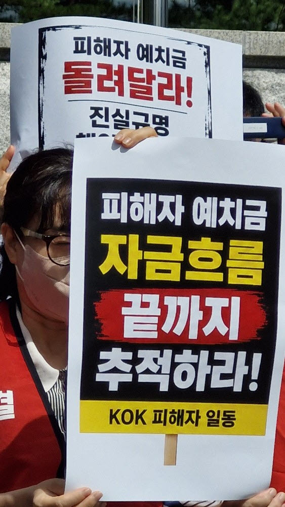 KOK코인 사건 한 피해자가 피해자 예치금의 자금흐름을 끝까지 추적하라는 손팻말을 들고 있다. (사진=최훈길 기자)