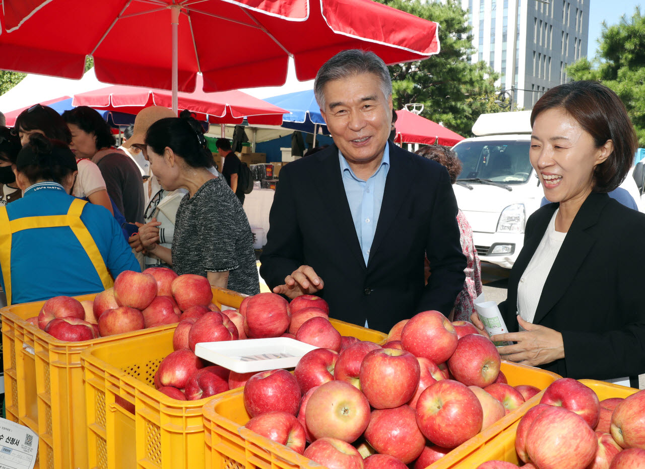김현기(앞줄 가운데) 강남구청장이 16일 강남구청에서 열린 ‘2026 추석맞이 강남구 직거래장터’에서 부스를 순회하며 상인 및 주민들과 인사를 하고 농산물을 살펴보고 있다. (김태형 기자)