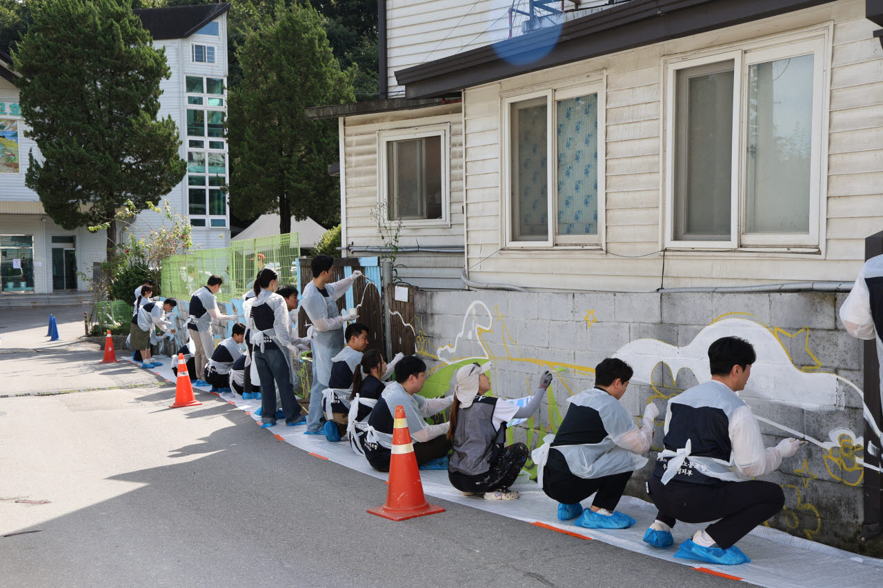 우리은행 노조원들이 지난 17일 경기 남양주시 낙원지역아동센터에서 벽화 봉사활동을 하고 있다.(사진=우리은행 노동조합)