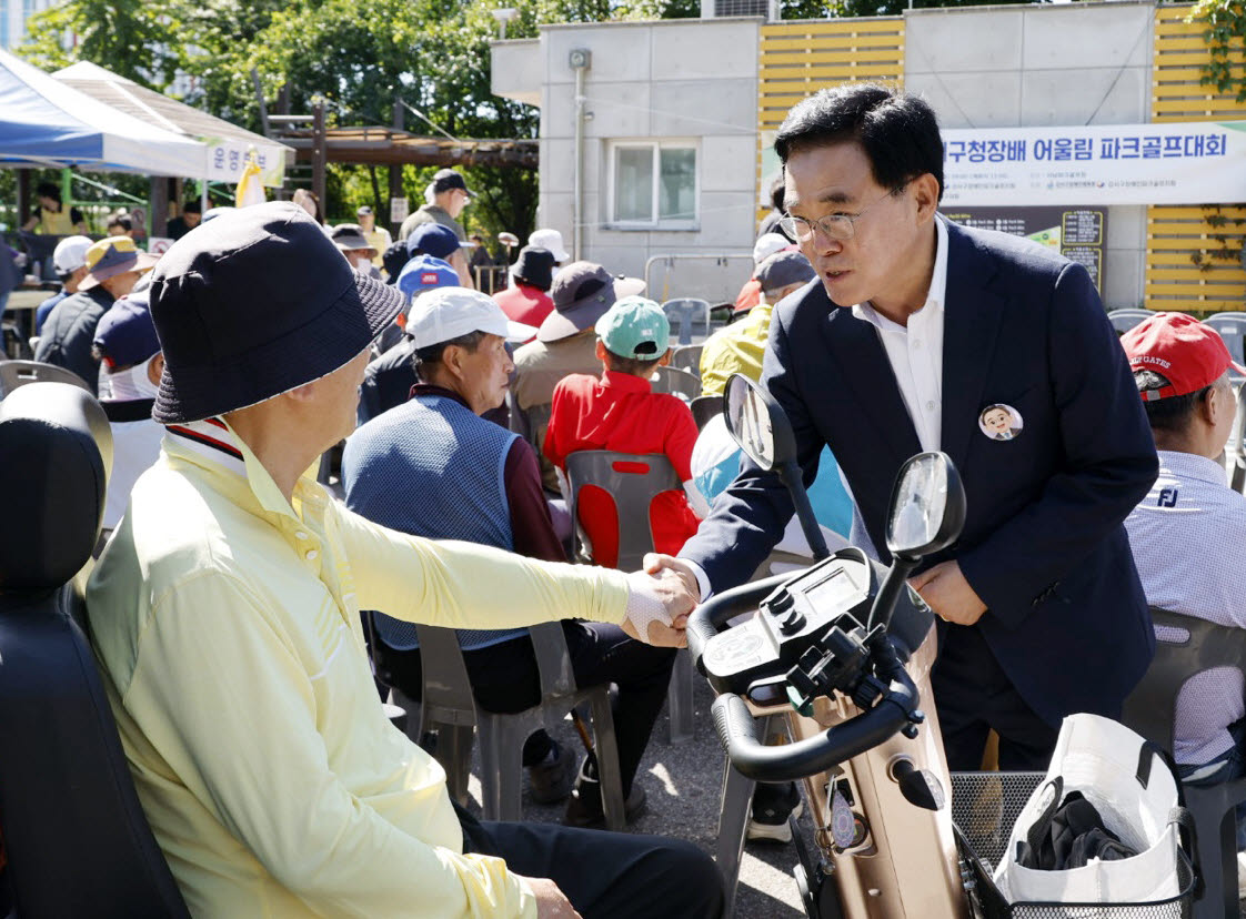 진교훈(오른쪽) 강서구청장이 19일 파크골프대회에 참석해 구민과 인사를 나누고 있다.