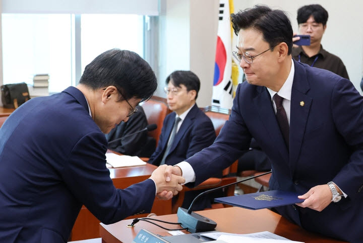 김정관 산업통상부 장관이 6일 국회에서 열린 산업통상자원중소벤처기업위원회 국정감사에서 김성원 위원장에게 선서문을 제출한 뒤 악수하고 있다.(사진=연합뉴스)