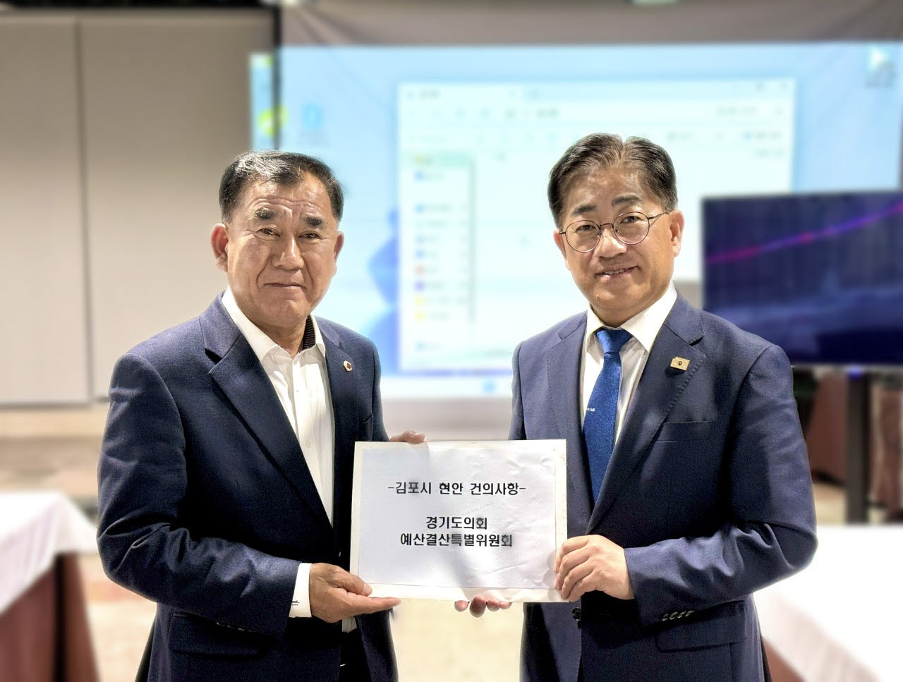 이기형(오른쪽) 김포시장이 시청에서 경기도의회 백승기 예산결산특별위원장에게 내년도 시 주요 사업에 대한 도비 확보 건의서를 전달하고 기념 촬영하고 있다. (사진 = 김포시 제공)