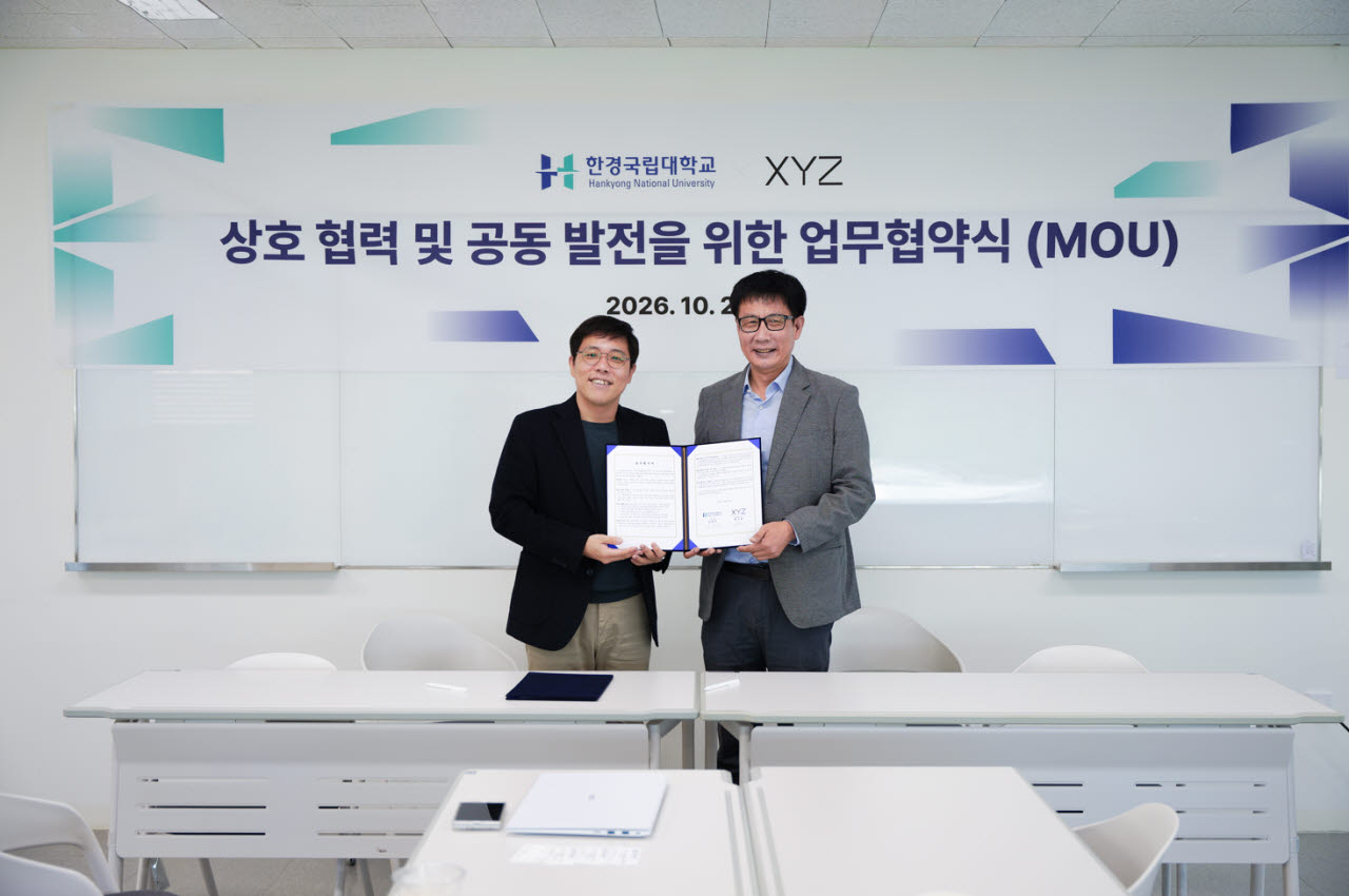 송호진 엑스와이지 로봇사업그룹 그룹장(왼쪽)과 김태준 한경국립대학교 장애인기업가역량강화센터장(오른쪽)이 기념 사진을 찍고 있다. (사진=엑스와이지)