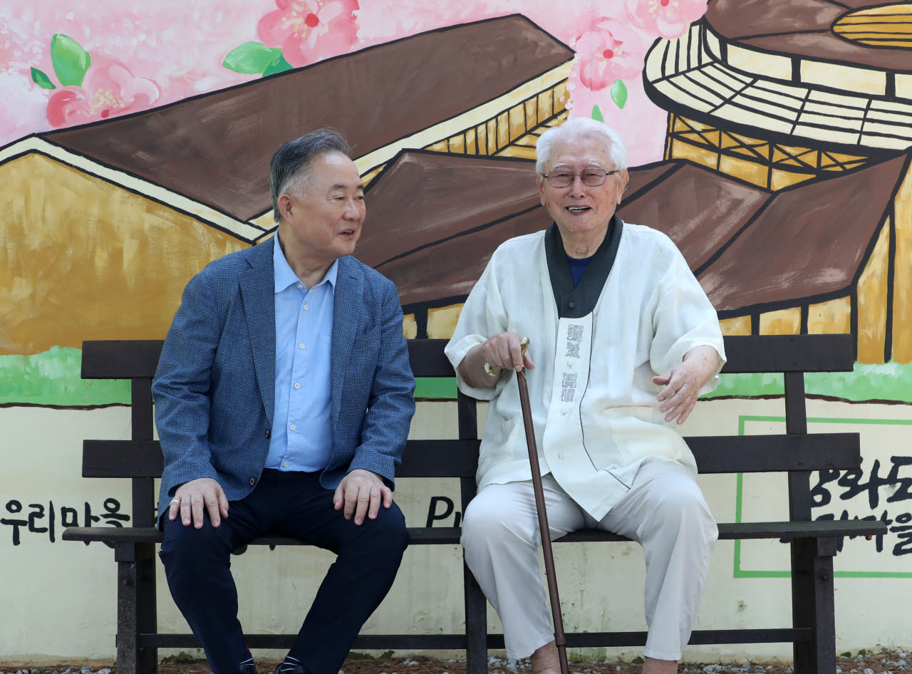 김성수 주교와 예종석 대기자가 '우리마을' 벽화 앞에서 이야기를 나누고 있다. (사진=김태형 기자)