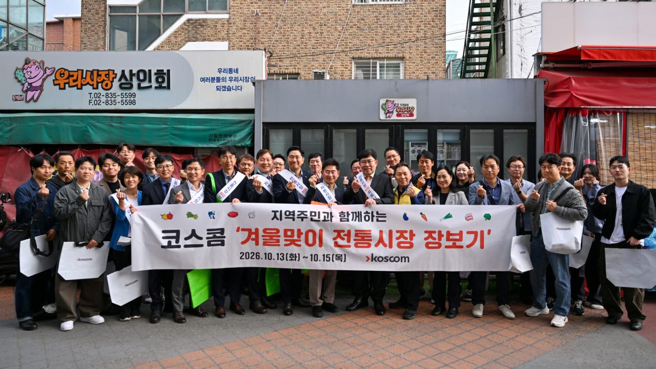 윤창현 코스콤 사장(가운데 오른쪽)이 임직원들과 함께 우리시장에서 ‘겨울맞이 전통시장 장보기’ 행사에 참여해 기념촬영을 하고 있다. (사진=코스콤)